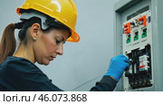 Female electrician working in switchboard with electrical connecting cable. Work in repair shops and maintenance services. Stress, nerves. Стоковое видео, видеограф ALLA YURTAYEVA / Фотобанк Лори