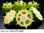 Sliced kiwano fruit showing intricate inner structure and seeds. Стоковое AI-изображение, AI-художник Иван Рябоконь / Фотобанк Лори