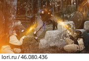 Group of friends paintball players of opposite teams in shootout in forest. Стоковое фото, фотограф Яков Филимонов / Фотобанк Лори