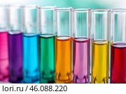 Test tubes filled with colorful chemical substances are standing in the laboratory. Стоковое AI-изображение, AI-художник Иван Рябоконь / Фотобанк Лори