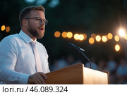Portrait of a handsome man speaking from tribune. Стоковое AI-изображение, AI-художник Евгений Харитонов / Фотобанк Лори