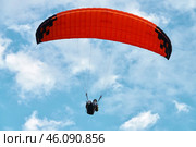 Close-up of a paraglider under an orange dome against a cloudy sky. Стоковое фото, фотограф Роман Дзюбало / Фотобанк Лори
