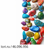 Colorful polished gemstones forming a vertical line on white background. Стоковое AI-изображение, AI-художник Иван Рябоконь / Фотобанк Лори