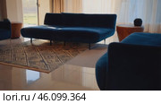 Living room with a blue couch and a rug. Стоковое AI-видео, аниматор Sergey Grishin / Фотобанк Лори
