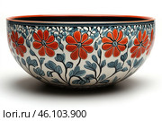 Ceramic bowl with an exquisite floral pattern. The background of the bowl is light, and the painting is done in red, blue and black shades. Large red flowers with a dark center, surrounded by thin black stems and blue leaves, are placed along the entire perimeter of the product. The upper edge of the bowl is painted in a rich terracotta color, which gives it additional expressiveness. The inside of the bowl is dark, creating a contrast with the external pattern. Стоковое AI-изображение, AI-художник Анна Кривицкая / Фотобанк Лори