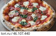 Hot baked italian pizza from the stone oven with fresh steam in the pizzeria. Pizza with its ingredients - meat, mozzarella, soft burrata, tomato, basil, olive oil, dough base. Italian cuisine concept. Стоковое AI-видео, аниматор Ирина Михайличенко / Фотобанк Лори