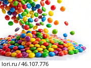 Colorful dragee candies in the assortment on a white background. Various sweets, confectionery and dragees of different shapes and colors. Bright rainbow hues. Стоковое AI-изображение, AI-художник Photojuli / Фотобанк Лори
