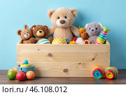 Wooden box with children's toys. A container with a teddy bear and educational wooden toys on a light blue background. Стоковое AI-изображение, AI-художник Photojuli / Фотобанк Лори