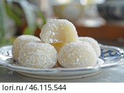 Delicious brazilian beijinho coconut candy balls resting on elegant plate. Стоковое AI-изображение, AI-художник Иван Рябоконь / Фотобанк Лори