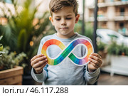 A colorful sign of the endless rainbow of autism in the hands of a boy. World Autism Awareness Day, the Autistic rights movement. Society's acceptance of autism. Стоковое AI-изображение, AI-художник Photojuli / Фотобанк Лори