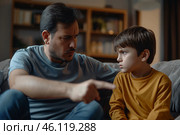 Father sternly addressing his son during an important conversation at home in the evening hours. Стоковое AI-изображение, AI-художник Sergey Grishin / Фотобанк Лори