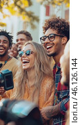 Young woman laughing with friends at outdoor event. Стоковое AI-видео, аниматор Юрий Поздников / Фотобанк Лори