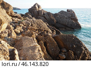 Waves gently crash against the rugged rocks while the sun sets over the horizon. Experience the serene beauty of this coastal location filled with natural wonders. Canj, Montenegro, Adriatic sea (2024 год). Стоковое фото, фотограф Юлия Петровская / Фотобанк Лори