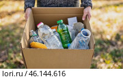 Cropped unrecognized person carrying crate of empty plastic bottles. Recycling plastic concept. Hands with Recycle Bin. Littering of environment. Problem of global plastics pollution of the Earth. Стоковое AI-видео, аниматор Марина Демидюк / Фотобанк Лори