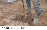 Engaging in the Process of Digging Soil Using a Tool in Natural Ground Conditions. Стоковое видео, видеограф Громов Александр / Фотобанк Лори