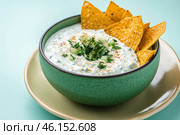 Traditional Greek Tzatziki dip sauce made with cucumber sour cream. Yogurt sauce with dill, lemon juice, olive oil. Served with toasted Za'atar Pita bread. Top view. Tarator, cacik or tartar. Стоковое AI-изображение, AI-художник Марина Демидюк / Фотобанк Лори