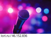 Microphone on the stage in concert hall or conference room. Close-up of a microphone in focus with a blurred pink purple bokeh background. Public speaking and live events concept. Neon light. Audience. Стоковое AI-изображение, AI-художник Марина Демидюк / Фотобанк Лори