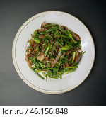 fried pork with herbs and vegetables on a white plate. Стоковое фото, фотограф Abakumova Ekaterina / Фотобанк Лори