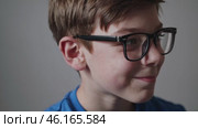 Thoughtful Boy Wearing Glasses Expressing Different Emotions. Стоковое видео, видеограф Данил Руденко / Фотобанк Лори