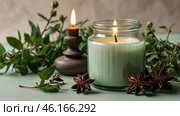 A mock-up of a comfortably burning candle made of glass with an empty white label and greenery in a home interior. Стоковое AI-изображение, AI-художник Photojuli / Фотобанк Лори
