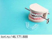 Artificial jaw, dental mirror and occlusal splint on color background. Стоковое фото, фотограф Pixel_shot / Фотобанк Лори