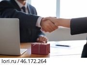 Businessman shaking hands with woman after bribery. Corruption concept. Стоковое фото, фотограф Pixel_shot / Фотобанк Лори