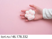 Taba paw pink and white colorful anti-stress toys squirt on baby's hand. Стоковое фото, фотограф Терехова Марина / Фотобанк Лори