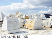 Large, raw marble blocks are scattered throughout a quarry site. Стоковое фото, фотограф Виктория Тельминова / Фотобанк Лори
