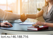 Man and lawyer shaking hands in office. Стоковое фото, фотограф Pixel_shot / Фотобанк Лори
