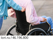 Young man with physical disability and his wife outdoors. Стоковое фото, фотограф Pixel_shot / Фотобанк Лори