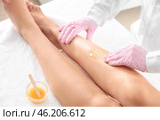 Beautician epilating legs of young woman in salon. Стоковое фото, фотограф Pixel_shot / Фотобанк Лори