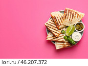 Plate with tasty quesadillas, lime, sauce and pickled jalapenos on color background. Стоковое фото, фотограф Pixel_shot / Фотобанк Лори