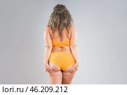 Overweight thigh, woman with fat hips, back and buttocks, obesity female body with cellulite on gray background. Стоковое фото, фотограф Станислав Тарко / Фотобанк Лори