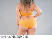 Overweight thigh, woman with fat hips, back and buttocks, obesity female body with cellulite on gray background. Стоковое фото, фотограф Станислав Тарко / Фотобанк Лори