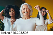 Mixed race women with raised fists of empowerment, strength and women solidarity, International Womens Day concept. Стоковое AI-изображение, AI-художник Анастасия Золотницкая / Фотобанк Лори