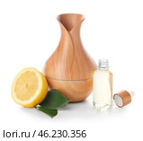 Aroma oil diffuser and lemon on white background. Стоковое фото, фотограф Pixel_shot / Фотобанк Лори