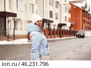 Chilly Winter Stroll Through a Peaceful Neighborhood Under a Serene Snowy Sky. Стоковое фото, фотограф Aleksandr Golubev / Фотобанк Лори