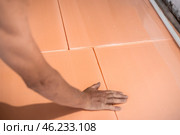 Worker lays polystyrene foam on the floor. Insulation of the house, installation of underfloor heating. Стоковое фото, фотограф Коханова Наталья / Фотобанк Лори