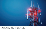 Communication tower stands tall against a darkening sky illuminated by red lights. Стоковое AI-изображение, AI-художник Александр Довянский / Фотобанк Лори