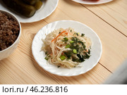 sauerkraut cabbage on a wooden background symbolizes a quiet conversation with God, which occurs through a prayer and reading a word during fasting. Стоковое фото, фотограф Скрипачев Антон / Фотобанк Лори