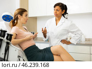 Young woman discussing breast augmentation with female doctor. Стоковое фото, фотограф Яков Филимонов / Фотобанк Лори