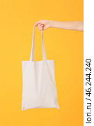 Female hand with eco bag on color background. Стоковое фото, фотограф Pixel_shot / Фотобанк Лори