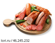 Wooden board with assortment of sausages on white background. Стоковое фото, фотограф Pixel_shot / Фотобанк Лори