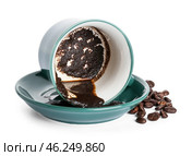 Cup with spent coffee grounds for fortune telling on white background. Стоковое фото, фотограф Pixel_shot / Фотобанк Лори
