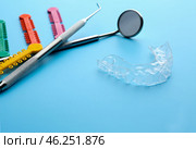 Dental instruments and occlusal splint on color background. Стоковое фото, фотограф Pixel_shot / Фотобанк Лори