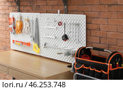 Desk and pegboard with modern tools in workshop. Стоковое фото, фотограф Pixel_shot / Фотобанк Лори