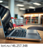 A small cart from the supermarket is on the laptop keyboard. The concept of online trading. Стоковое AI-изображение, AI-художник Евгения Харлампьева / Фотобанк Лори