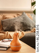 Aroma oil diffuser on table in room. Стоковое фото, фотограф Pixel_shot / Фотобанк Лори