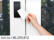 Woman using card to open door outdoors. Стоковое фото, фотограф Pixel_shot / Фотобанк Лори