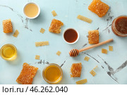 Composition with honey and combs on color table. Стоковое фото, фотограф Pixel_shot / Фотобанк Лори